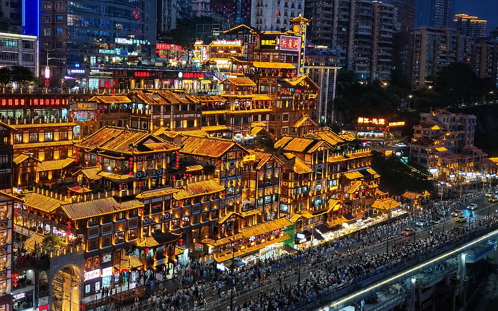 Hongya Cave glowing above Chongqing's rivers at night
